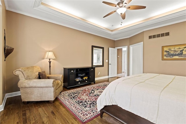 bedroom with baseboards, visible vents, dark wood-style flooring, and ornamental molding