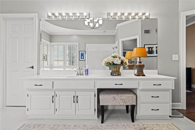 bathroom featuring double vanity, visible vents, ornamental molding, a sink, and tile patterned floors