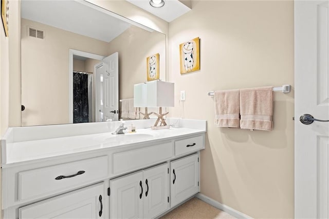 bathroom with tile patterned floors, baseboards, visible vents, and vanity