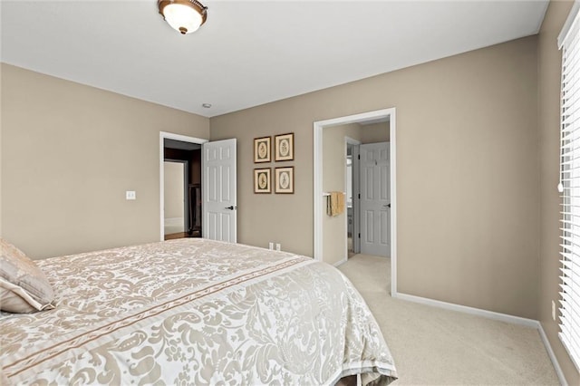 bedroom with baseboards and light colored carpet