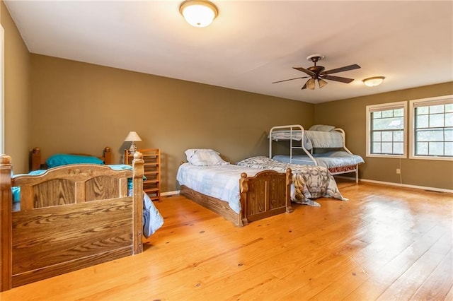 bedroom with ceiling fan and light hardwood / wood-style flooring