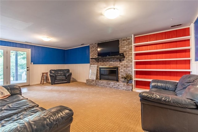 carpeted living room featuring built in features and a brick fireplace