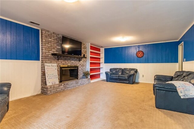 living room with built in shelves, carpet flooring, and a fireplace