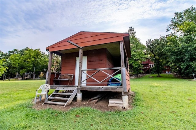 view of outbuilding featuring a yard