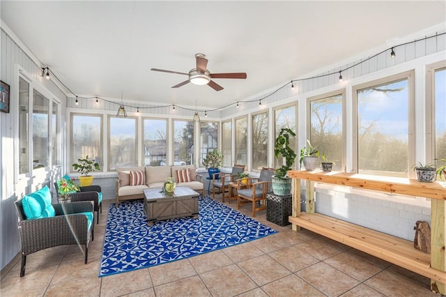 sunroom featuring ceiling fan