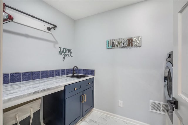 laundry room with cabinet space, baseboards, visible vents, marble finish floor, and a sink