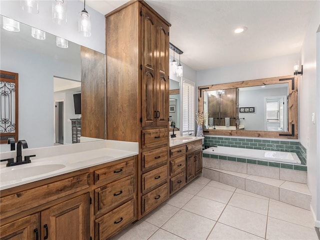 bathroom with a garden tub, double vanity, tile patterned flooring, and a sink