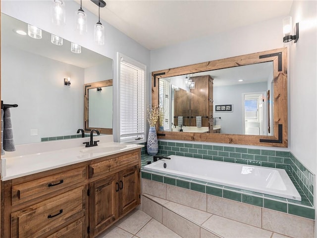 full bath featuring a garden tub, tile patterned flooring, and vanity