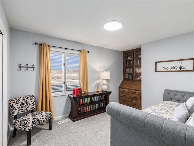 living room with carpet floors, baseboards, and visible vents