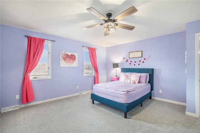 bedroom with baseboards, multiple windows, visible vents, and carpet flooring