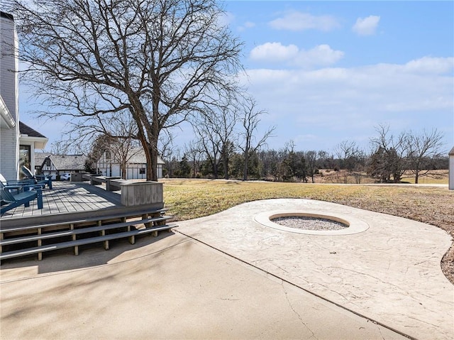 view of patio with a fire pit and a wooden deck