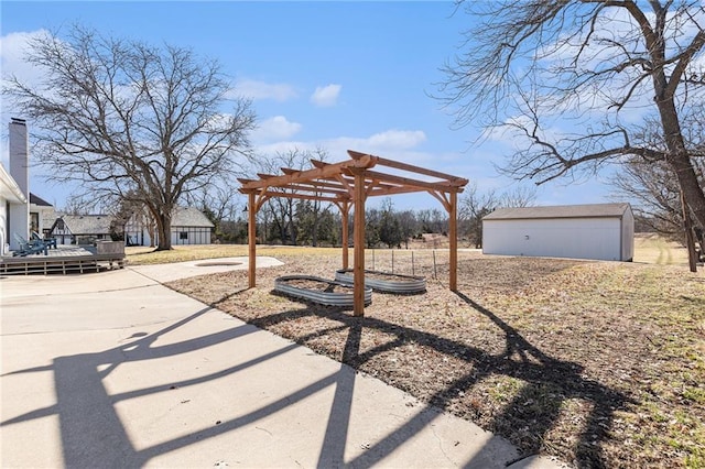 view of yard with a pergola and an outbuilding