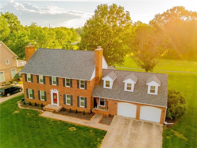 view of front of property with a garage and a front lawn