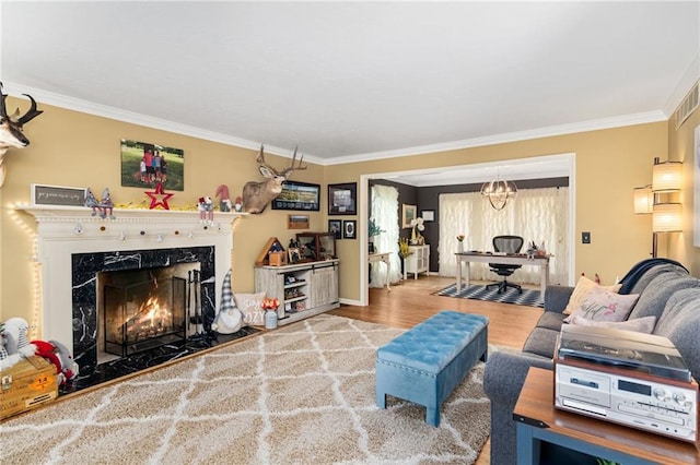 living area featuring wood finished floors, crown molding, and a premium fireplace