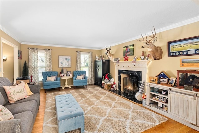 living room with ornamental molding, a premium fireplace, and light wood-type flooring