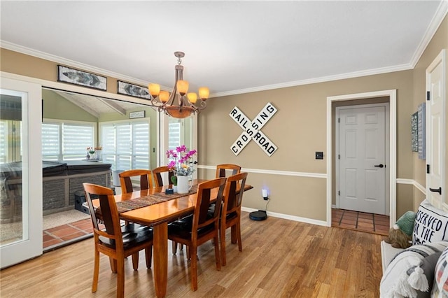 dining room with a notable chandelier, ornamental molding, and light wood-type flooring