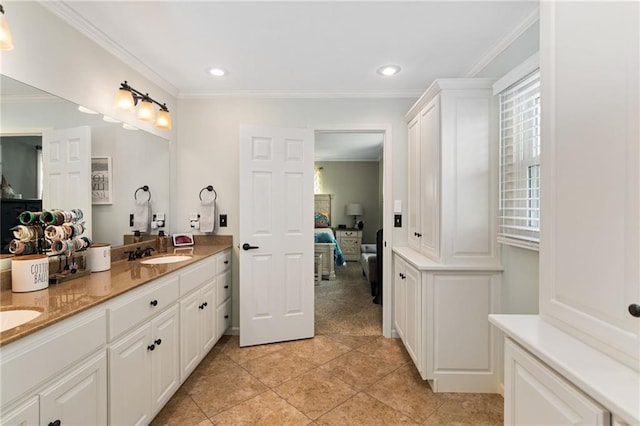 ensuite bathroom featuring tile patterned flooring, recessed lighting, a sink, ornamental molding, and double vanity