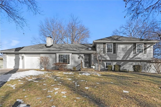 split level home with a garage and a front yard