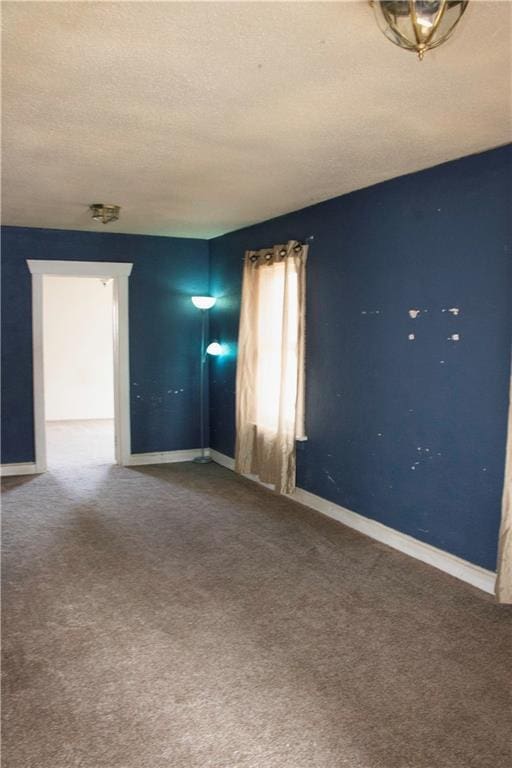 carpeted spare room featuring a textured ceiling