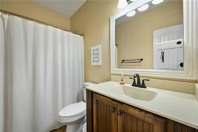 full bath featuring vanity and toilet