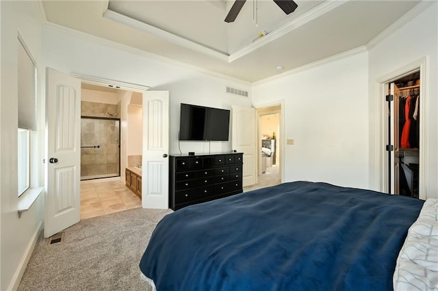 bedroom featuring visible vents, a raised ceiling, light carpet, and crown molding