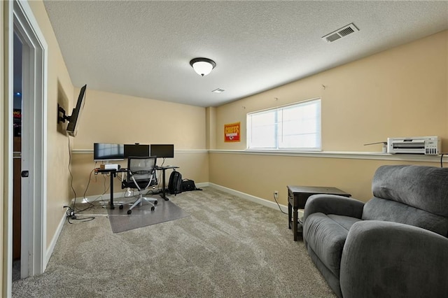 office with baseboards, visible vents, carpet floors, and a textured ceiling