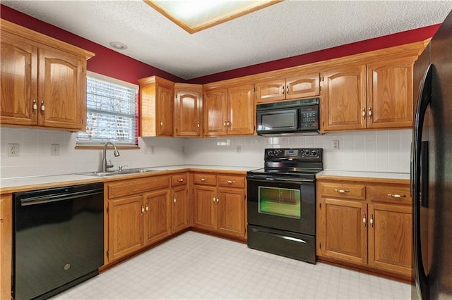 kitchen with tasteful backsplash, sink, a textured ceiling, and black appliances