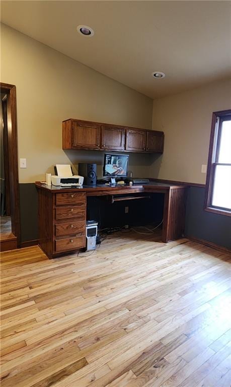 kitchen featuring lofted ceiling and light wood-type flooring