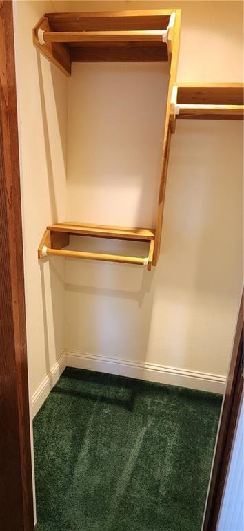 spacious closet featuring dark carpet