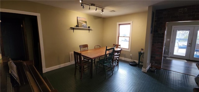 dining area with french doors and rail lighting