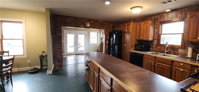 kitchen featuring french doors, a wealth of natural light, sink, and black appliances