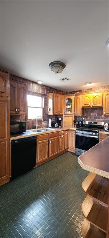 kitchen with sink, decorative backsplash, and black appliances