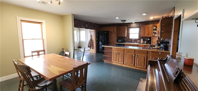 kitchen with sink, decorative backsplash, and black appliances