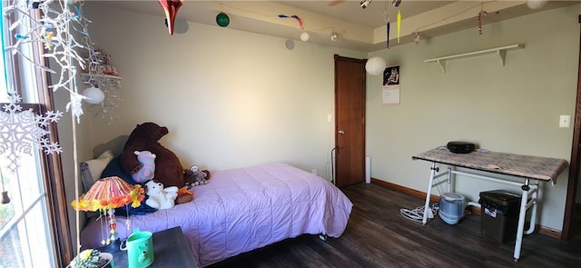 bedroom with dark hardwood / wood-style flooring