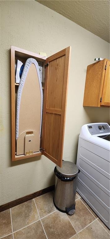 laundry room with cabinets, washer / dryer, tile patterned floors, and a textured ceiling