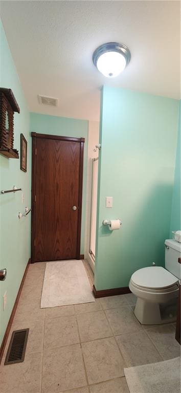 bathroom featuring tile patterned floors and toilet
