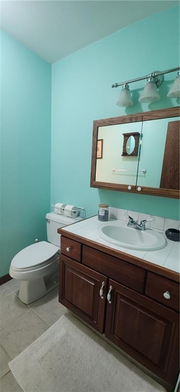 bathroom with vanity, tile patterned flooring, and toilet