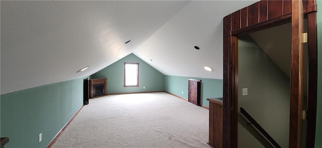 bonus room featuring lofted ceiling and light carpet