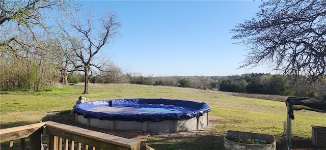 view of yard with a covered pool