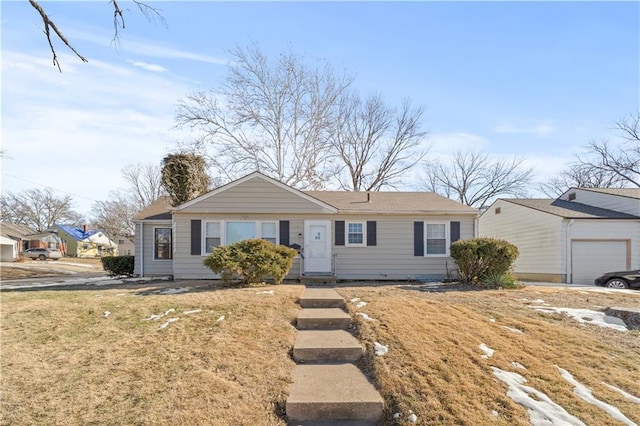 single story home featuring a garage and a front yard