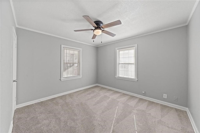 unfurnished room with crown molding, light colored carpet, and a textured ceiling