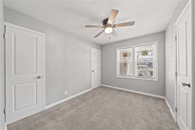 unfurnished bedroom with light colored carpet and ceiling fan