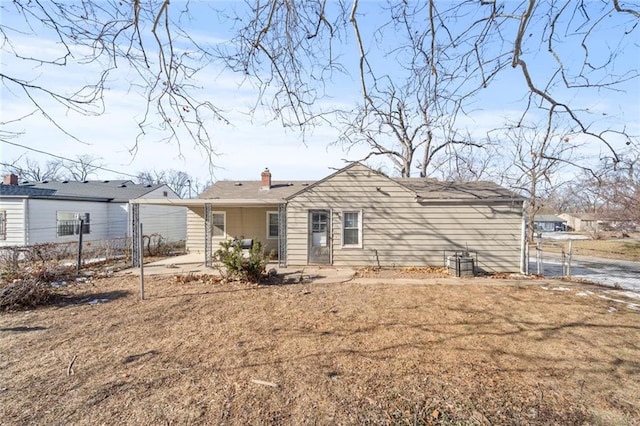 rear view of house featuring a lawn and a patio area