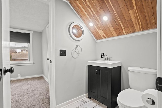 bathroom featuring vanity, vaulted ceiling, and toilet