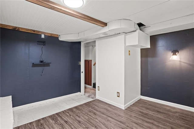 basement with hardwood / wood-style flooring