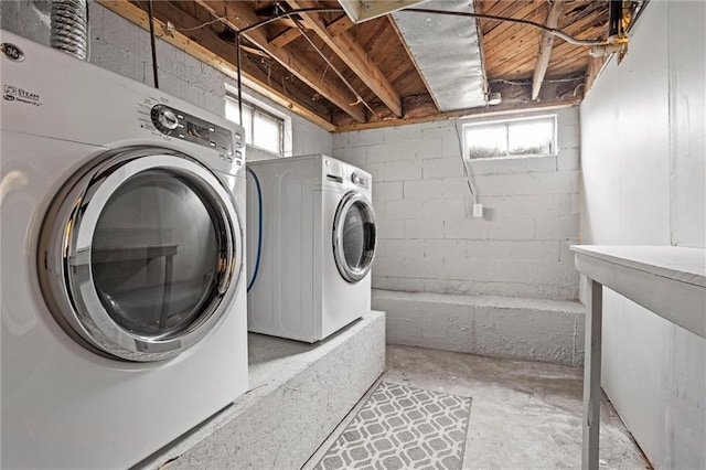 laundry area with a healthy amount of sunlight and washer and clothes dryer