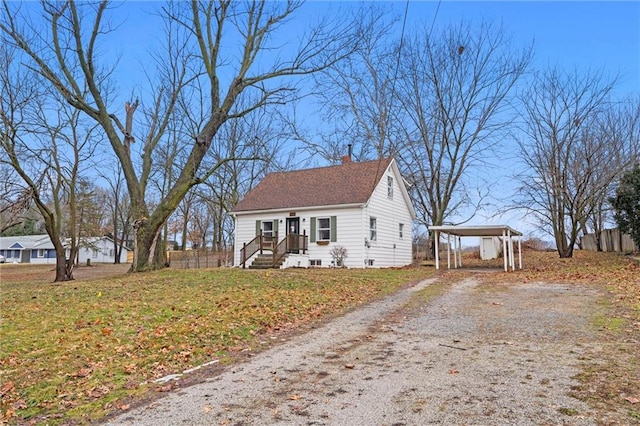 view of front facade featuring a front yard and a carport