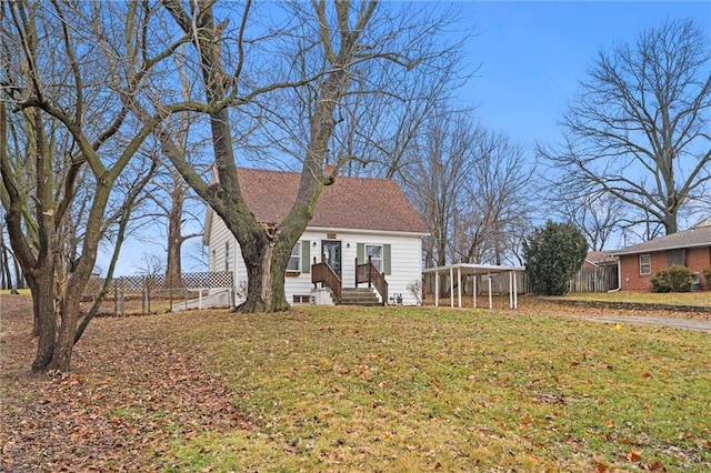 view of front of property with a carport and a front yard