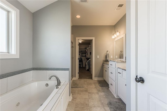 bathroom with vanity and a bathing tub