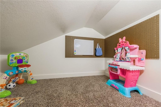 playroom with vaulted ceiling, carpet, and a textured ceiling